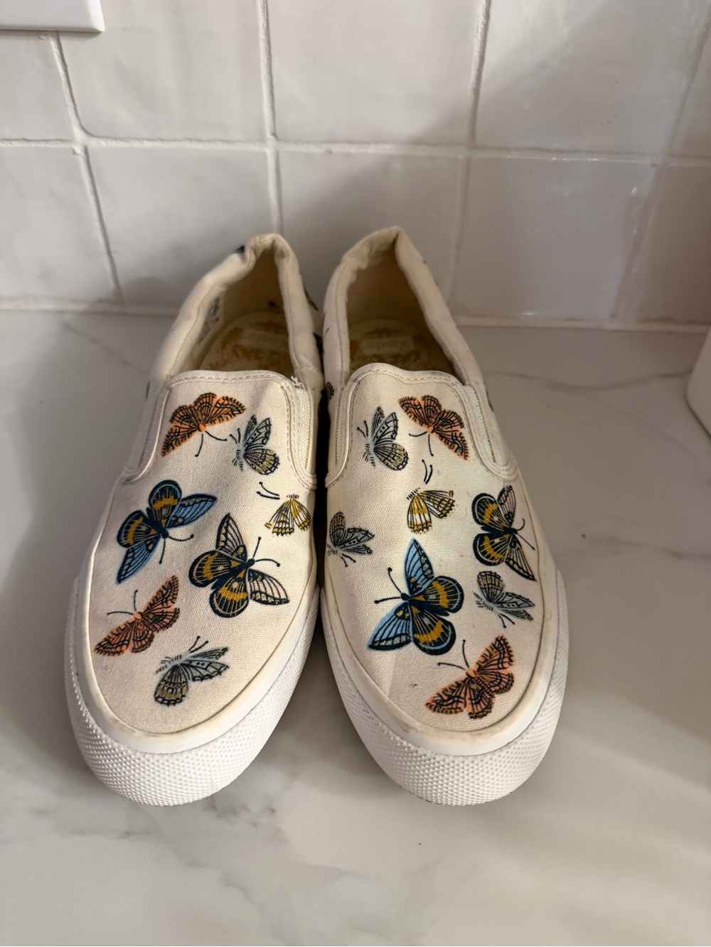 Keds Cream Slip-On Sneakers with Blue, Yellow, Orange & Black Butterfly Print